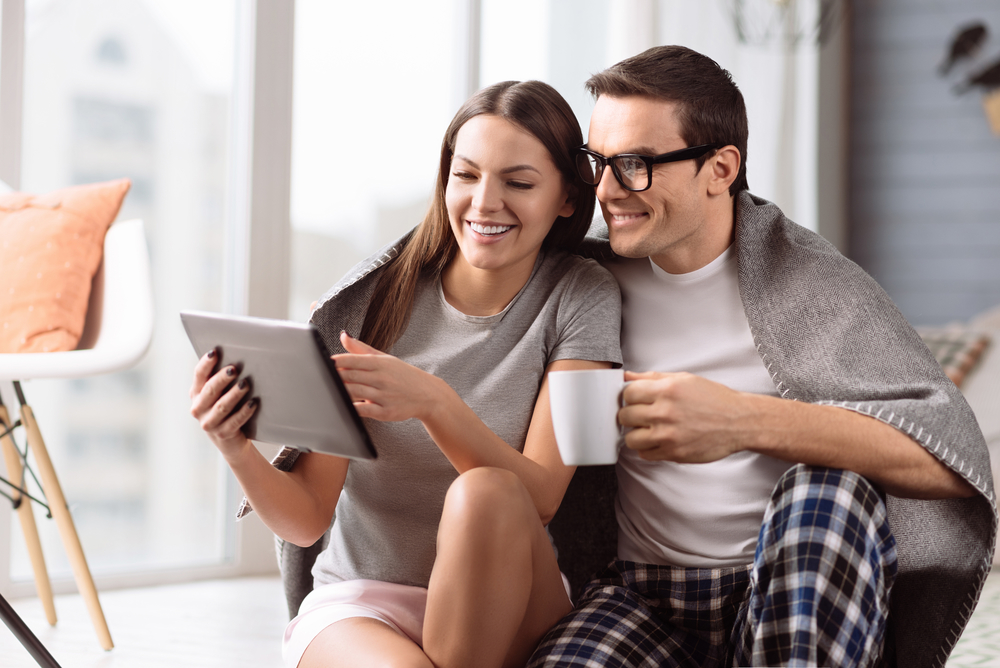 Happy cute woman holding a tablet