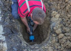 utility worker in trench repair the broken pipe 2