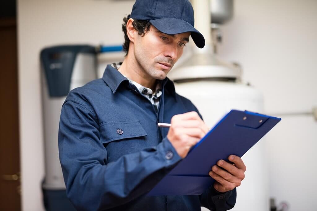 Plumber completing report for insurance after flood damage