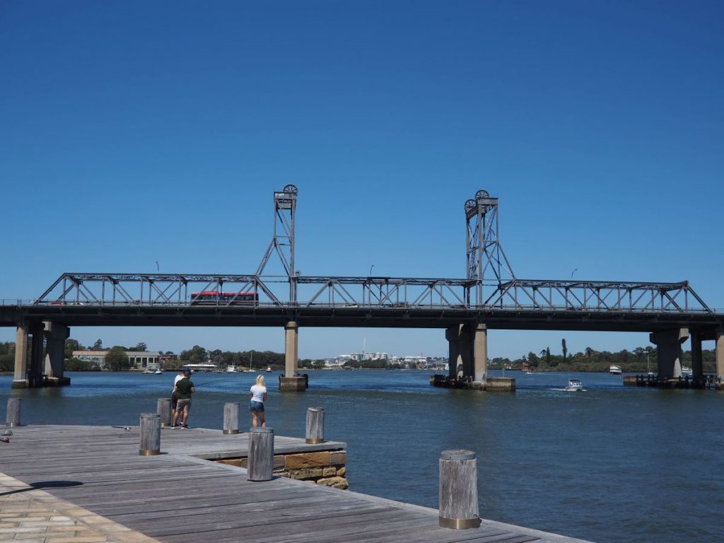 Industrial area next to river in Meadowbank. Industrial-looking bridge in midground. Gladesville Plumbing Services offers plumbing help in this North Sydney suburb.