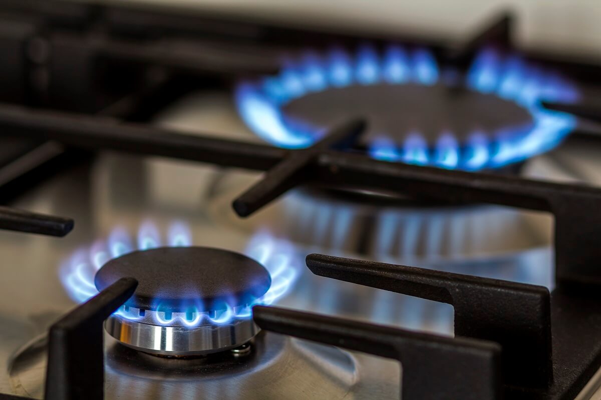 Two gas stove tops lit up with blue fire. Gas fitting, maintenance and gas leaks by professional plumbers and gas fitters North Sydney.