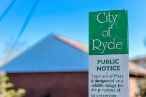 City of Ryde public notice sign regarding The Field of Mars wildlife refuge, within the Gladesville Plumbing service zone.