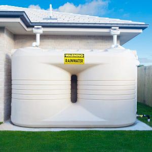 Rainwater tank in backyard, properly fitted by professional plumber in North Sydney.