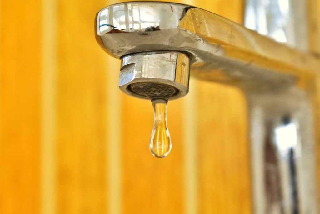 Dripping tap in yellow bathroom - replacing a taps sounds easy, until it isn't. Call in the professionals for your small plumbing job in Sydney