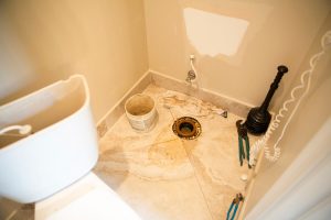 Toilet removed to replace seal, the cause of a leaking toilet and bathroom smells