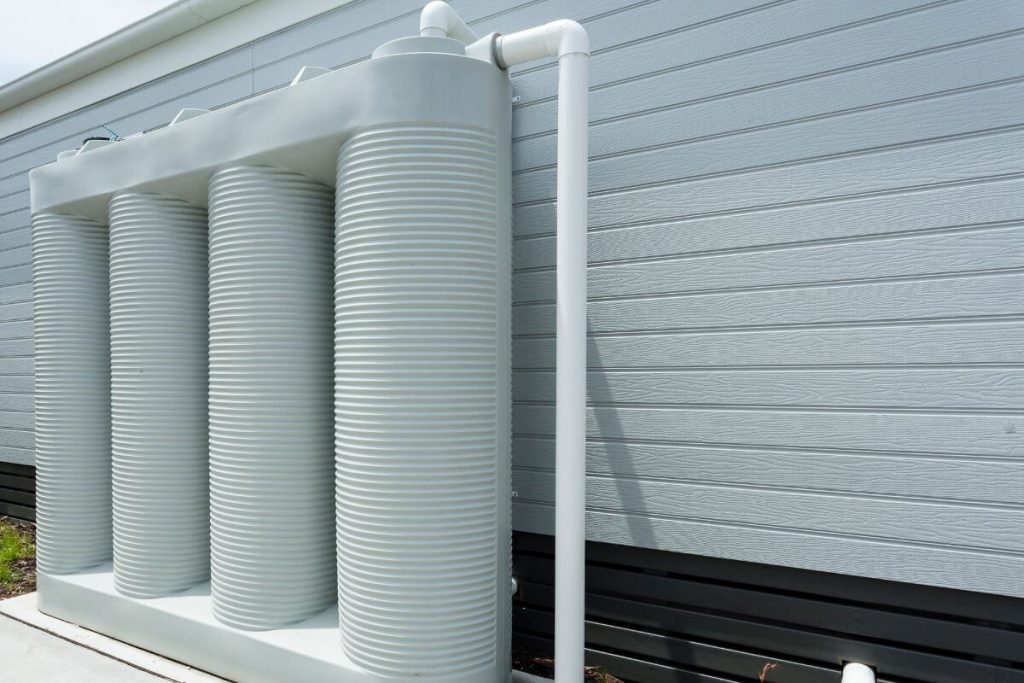 Narrow rainwater tank installed at side of home to save water at home
