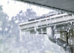 Gutters overflowing as heavy rain overwhelms roof drainage system