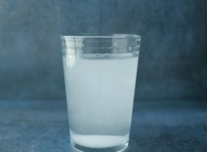 Cloudy water in glass - one sign of drinking water contaminated by old pipes
